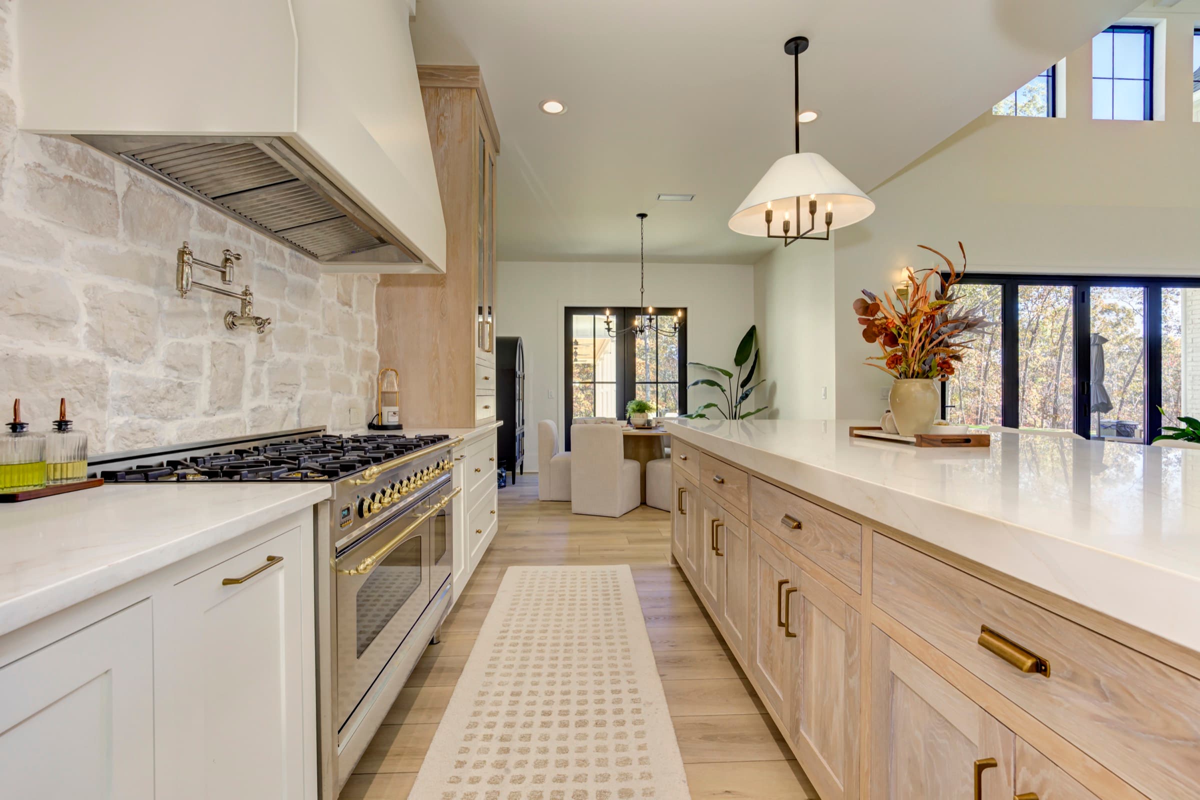 Craft detail: A professional brass range beneath a stacked-stone hood